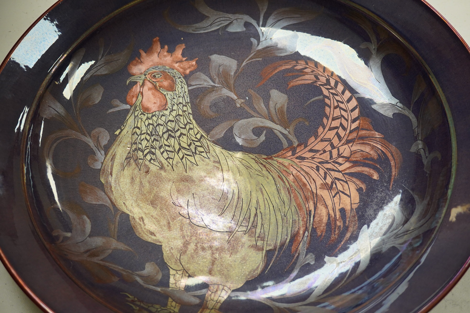 A Jonathan Chiswell Jones lustre dish decorated with a cockerel, 42.5cm diameter. Condition - good